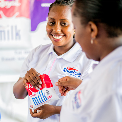 A lady sharing the delicious Royal Milk to a college